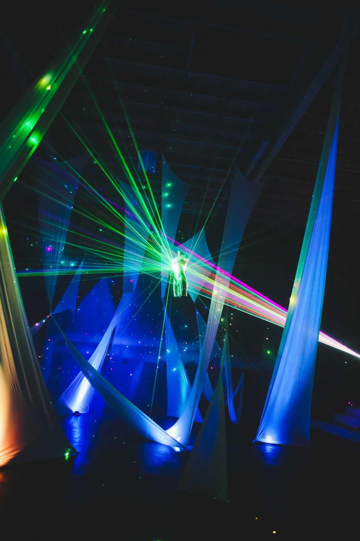 Disco B*tch sparkling amid sweeping fabric and green, blue, and pink light