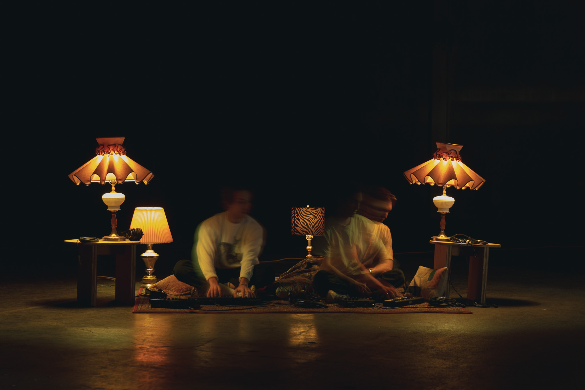 Sosh and Mosh performing together among glowing lamps