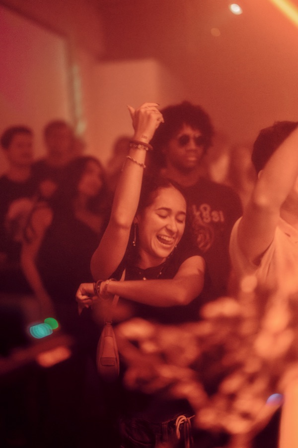 Smiling guest dancing in warm light