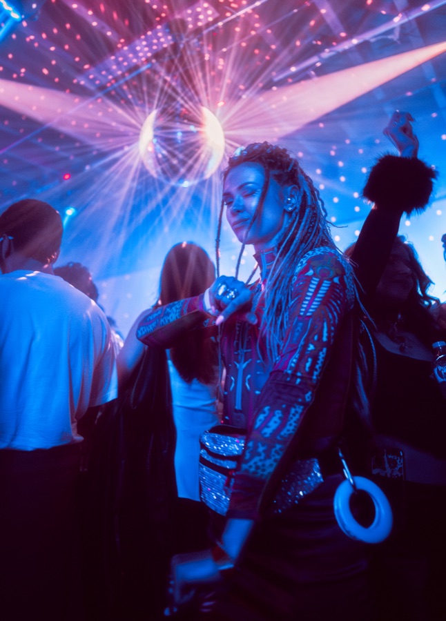 Guest dancing beneath blue and pink lights