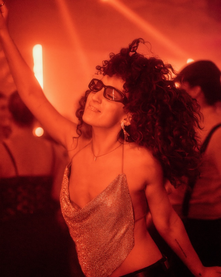 Guest dancing in warm red light